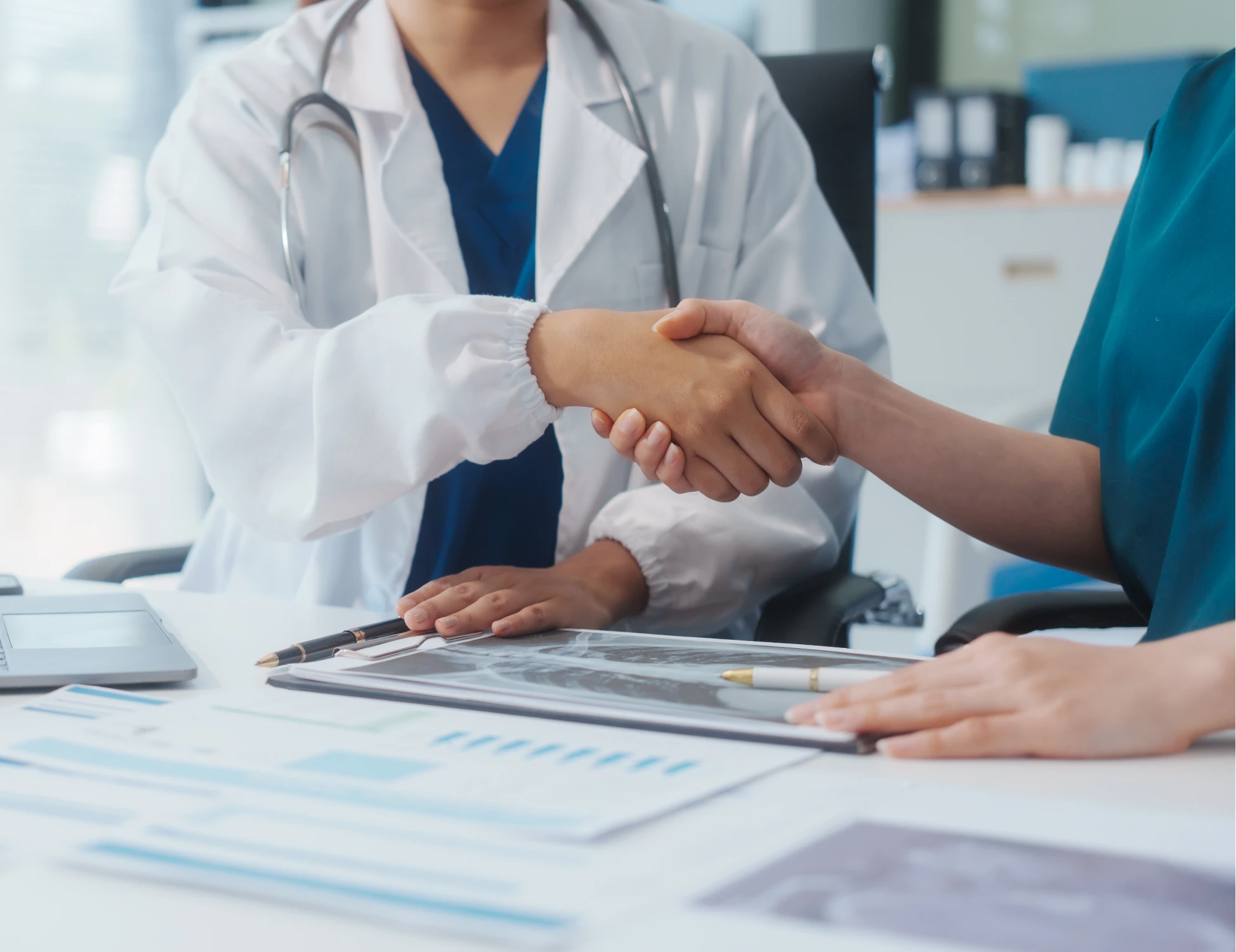 Medical consultation handshake in office